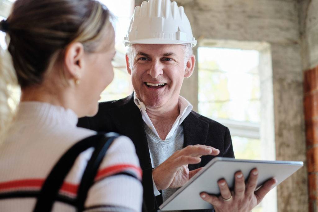 Sales agent talking with client in new building