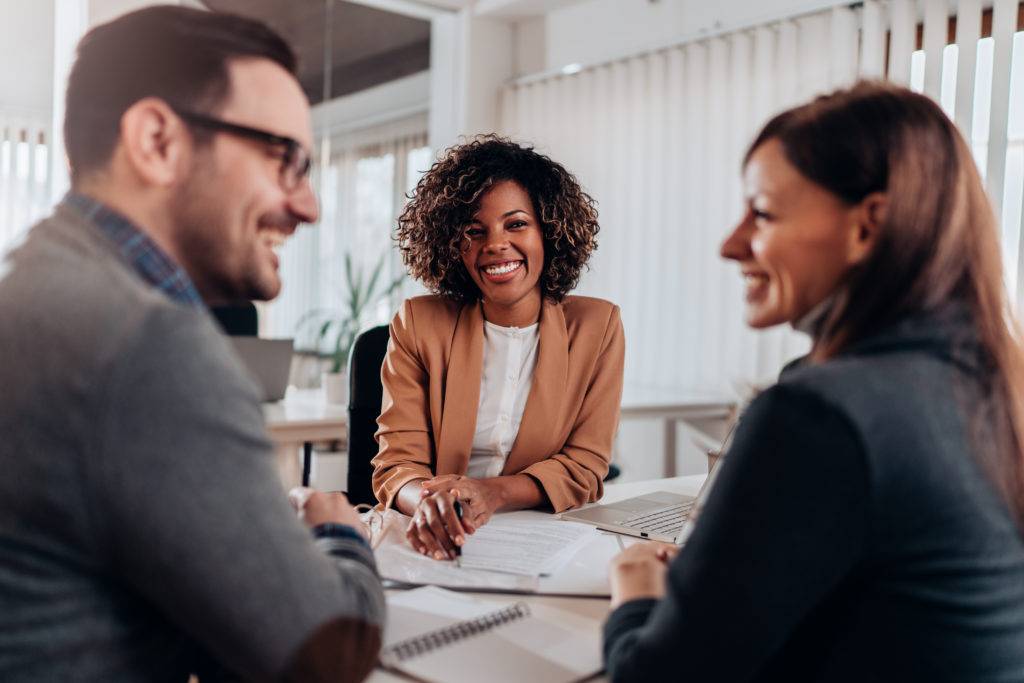 Couple consulting with a female financial manager