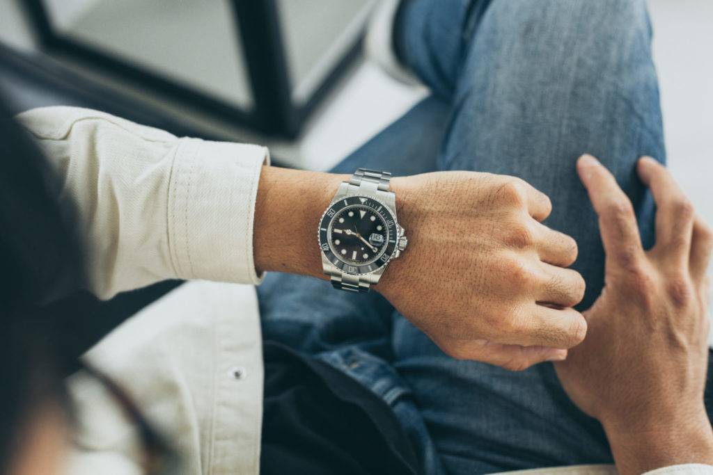 Male checking the time on a wrist watch
