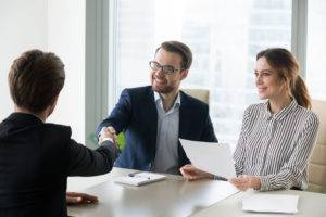Happy satisfied hr manager handshaking hiring successful male job candidate, smiling employer company executive shaking hand welcoming greeting seeker making good first impression, employment concept